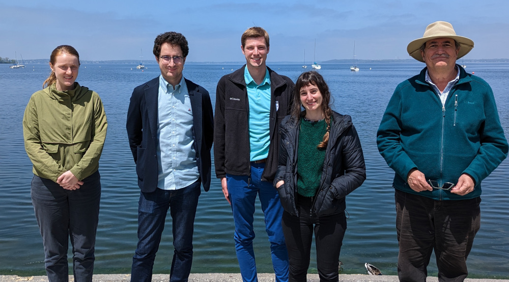 5 people standing in front of ocean