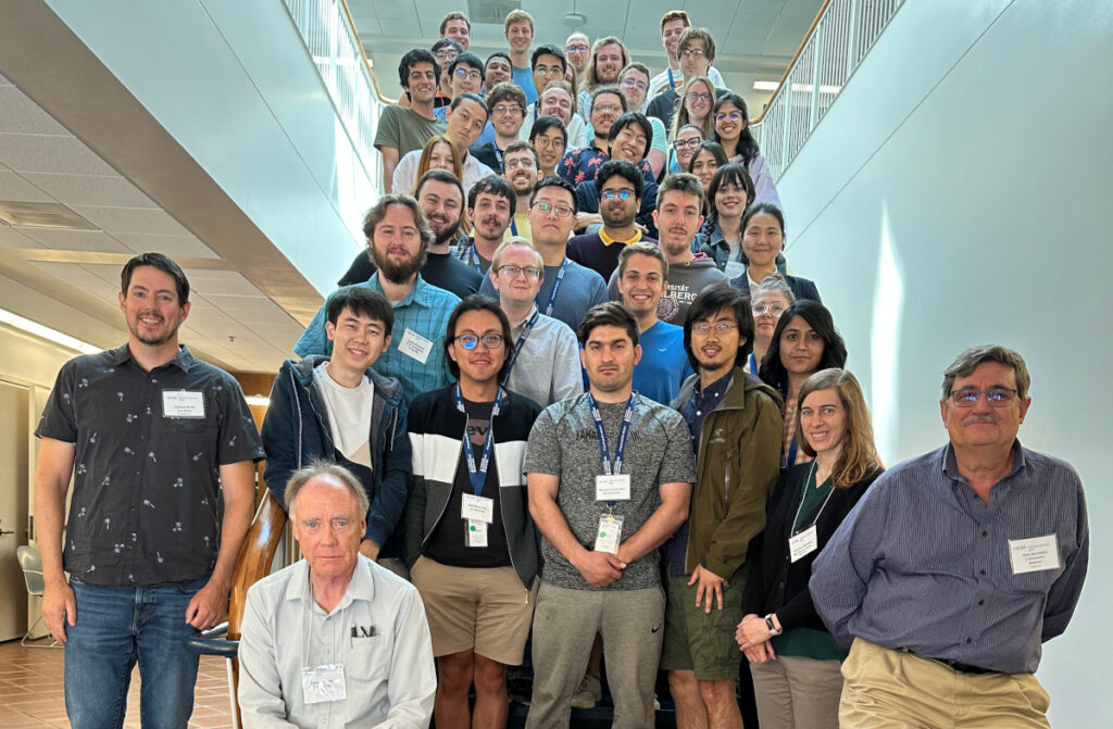 Dozens of summer school participants standing on stairs