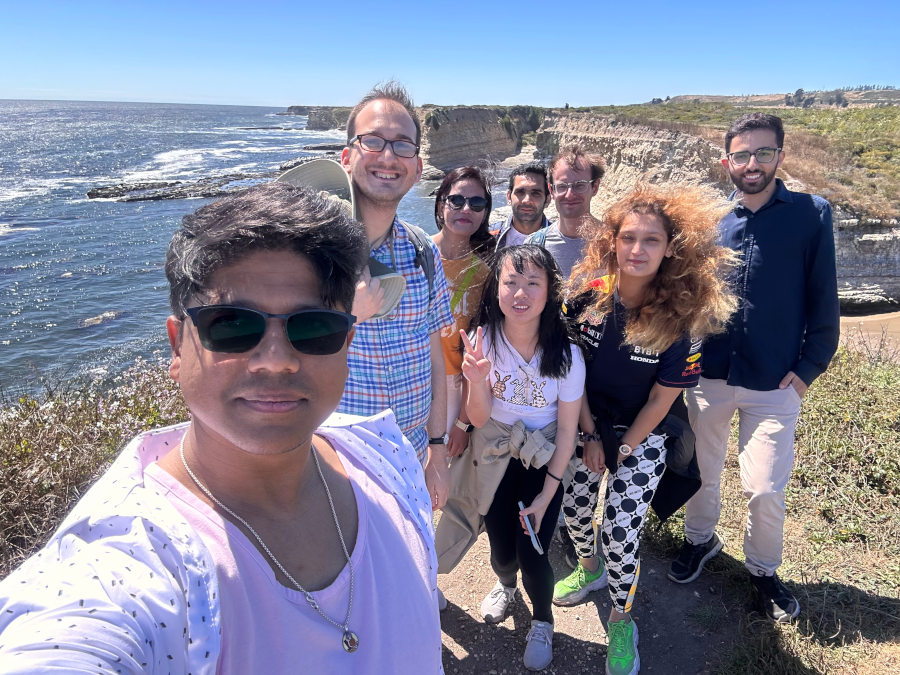 Group of people on cliffs above the ocean